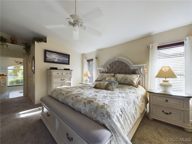 carpeted bedroom featuring ceiling fan and vaulted ceiling