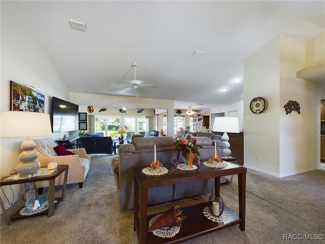 carpeted living room featuring ceiling fan and vaulted ceiling