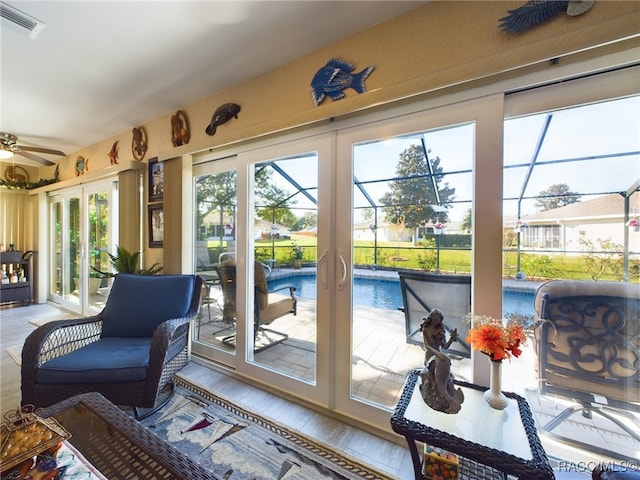 sunroom / solarium with french doors and ceiling fan