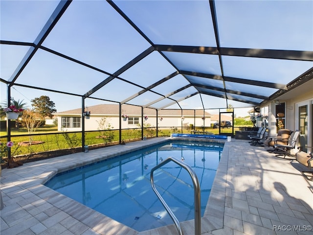 view of swimming pool with a patio and a lanai