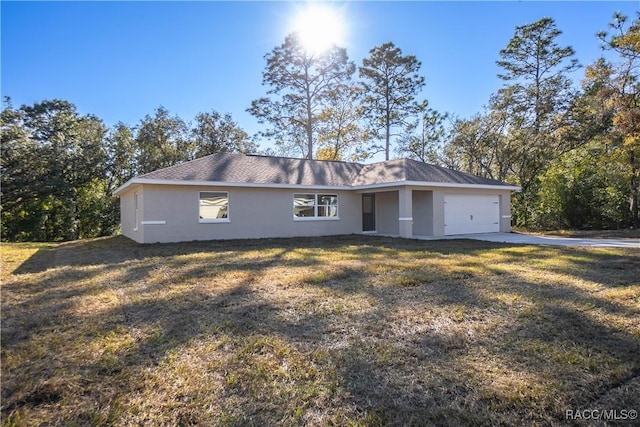 ranch-style house with a garage and a front yard