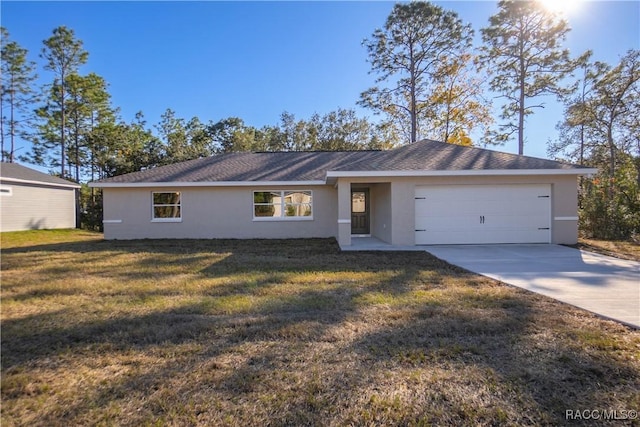 single story home featuring a garage and a front lawn