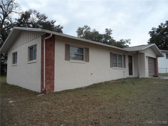 view of property exterior with a yard and a garage