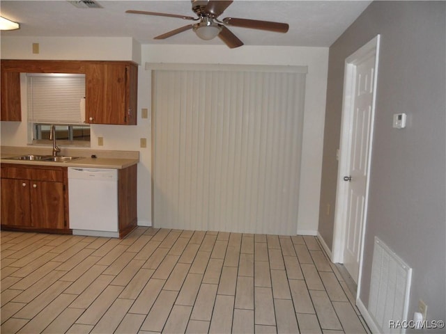 kitchen featuring sink, white dishwasher, ceiling fan, and light hardwood / wood-style flooring