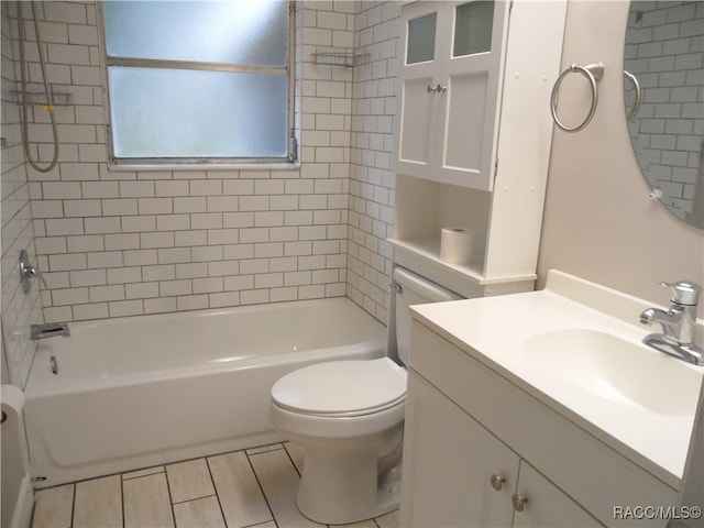 full bathroom with toilet, vanity, and tiled shower / bath combo