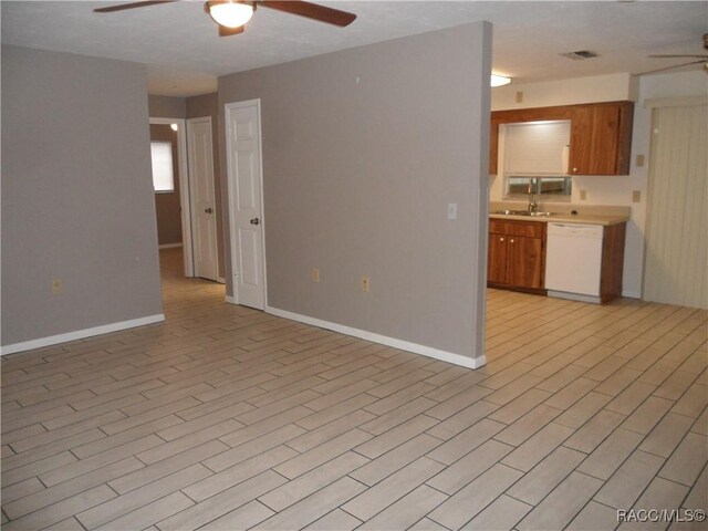 kitchen featuring white dishwasher, ceiling fan, and sink