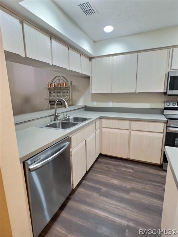 2058 Forest Dr, Inverness, FL 34453 - kitchen featuring stainless steel appliances, a sink, dark wood-style flooring, light countertops, and white cabinets