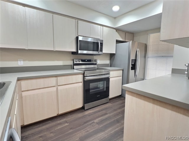 kitchen featuring light brown cabinets, dark hardwood / wood-style floors, and appliances with stainless steel finishes