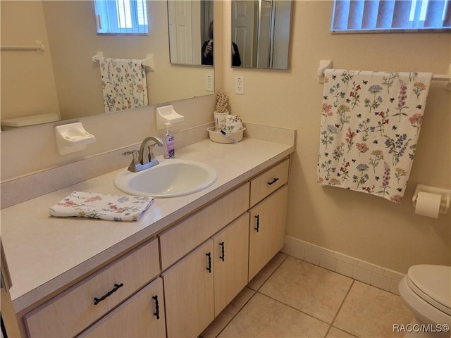 bathroom with tile patterned floors, vanity, and toilet