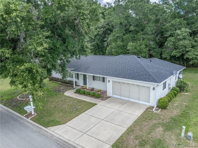 ranch-style house featuring a garage and a front yard