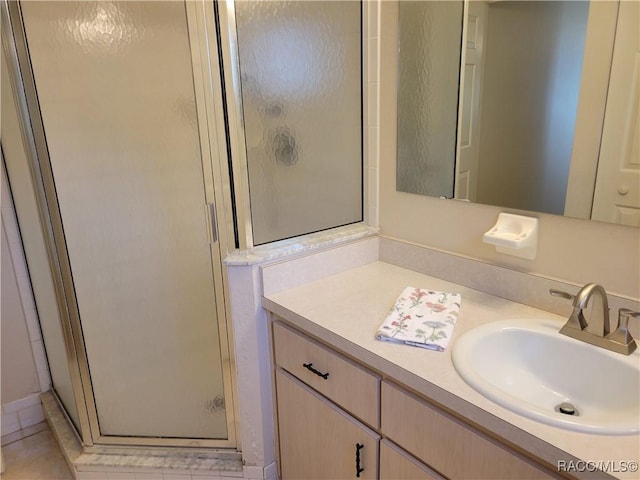 bathroom featuring vanity and a shower with shower door