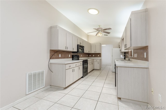 kitchen with ceiling fan, sink, black electric range oven, backsplash, and light tile patterned floors