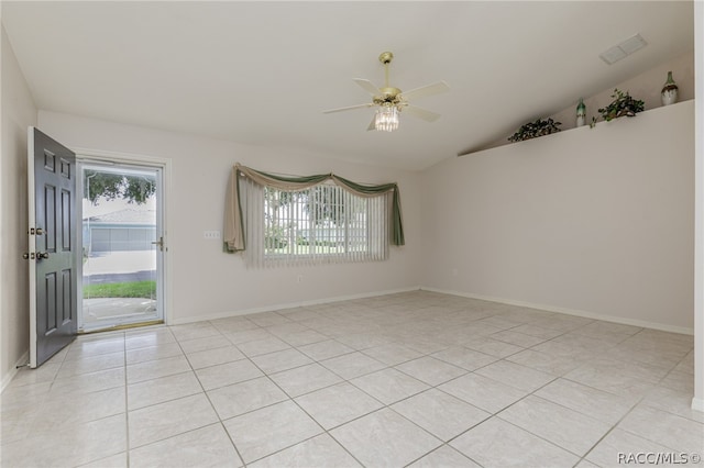 empty room featuring ceiling fan, light tile patterned flooring, and lofted ceiling