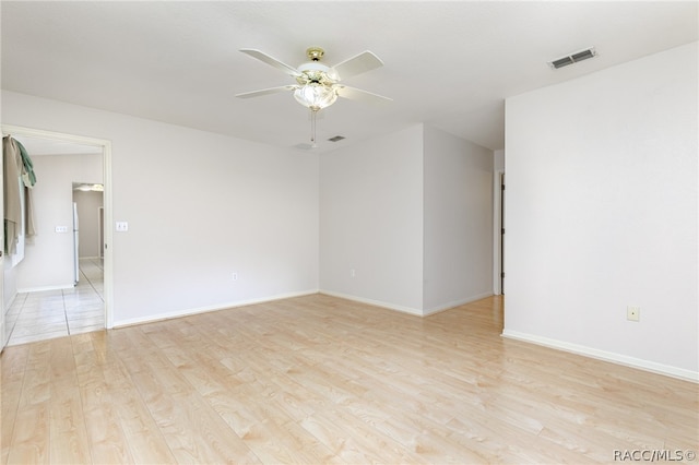 empty room with ceiling fan and light wood-type flooring