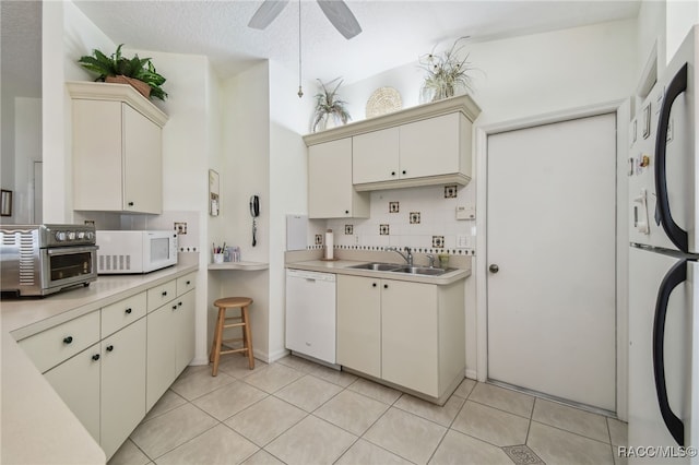 761 W Sunbird Path, Hernando, FL 34442 - kitchen with white appliances, cream cabinets, light countertops, and decorative backsplash