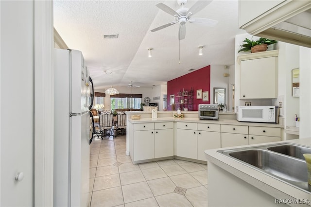 761 W Sunbird Path, Hernando, FL 34442 - kitchen with white appliances, ceiling fan, a peninsula, light tile patterned floors, and light countertops
