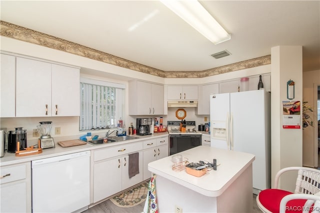 kitchen with a center island, white appliances, white cabinets, sink, and light wood-type flooring