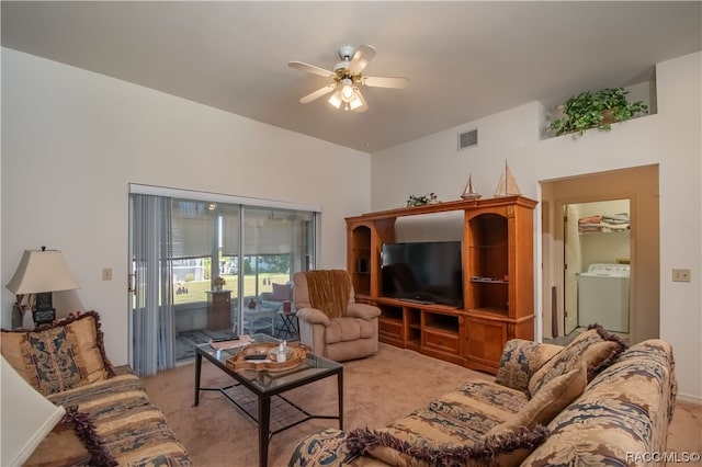 carpeted living room featuring washer / clothes dryer and ceiling fan