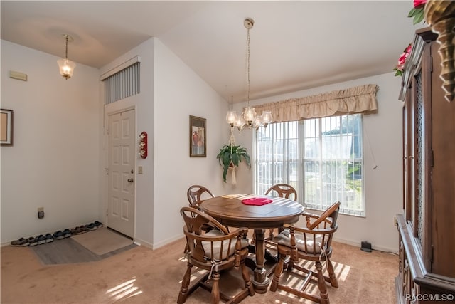 dining area with lofted ceiling, light carpet, and an inviting chandelier