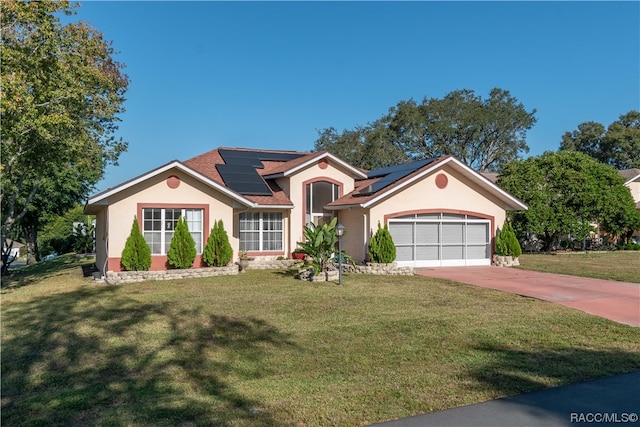 single story home featuring solar panels, a garage, and a front yard