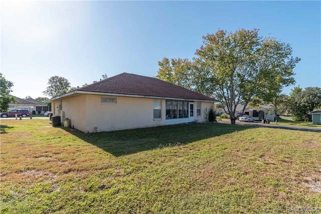 view of property exterior featuring a lawn and central AC unit