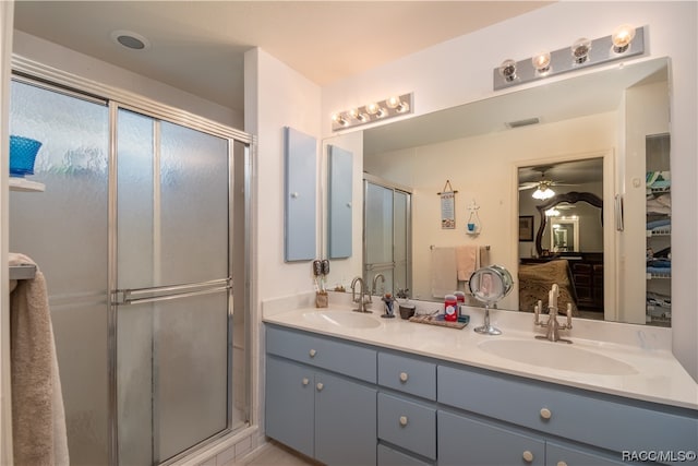 bathroom featuring ceiling fan, vanity, and walk in shower