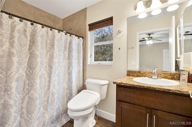 bathroom with baseboards, toilet, ceiling fan, curtained shower, and vanity