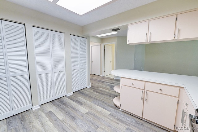 kitchen with white cabinets and light wood-type flooring