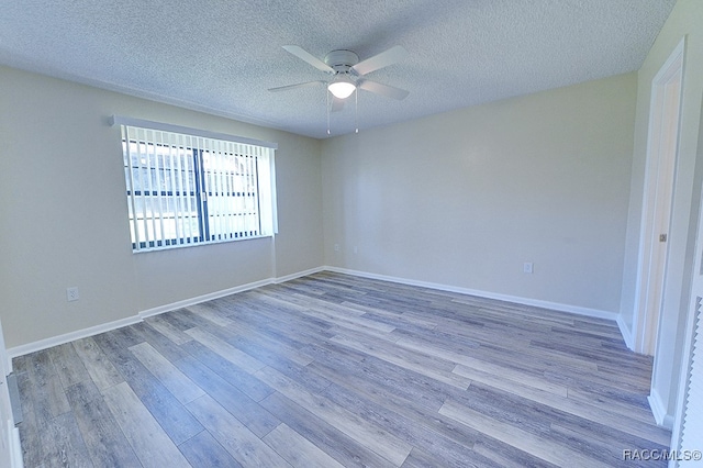 unfurnished room featuring a textured ceiling, light hardwood / wood-style floors, and ceiling fan