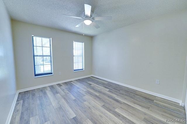 unfurnished room featuring a textured ceiling, light hardwood / wood-style floors, and ceiling fan