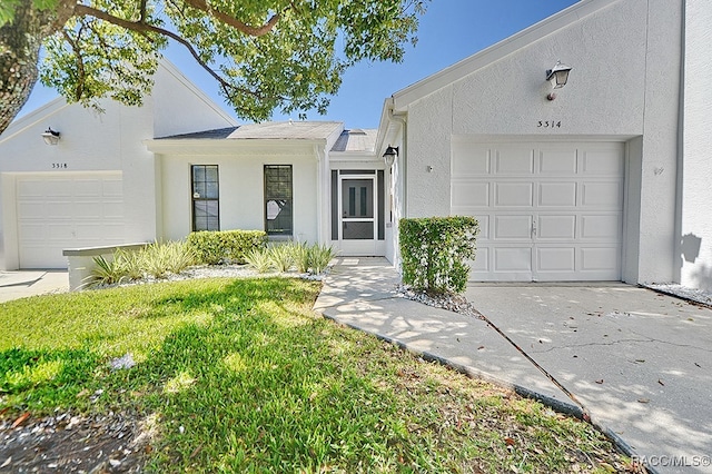 single story home with a front lawn and a garage