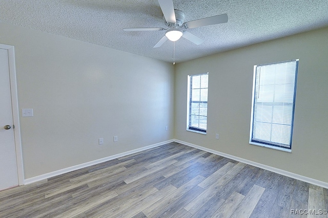 unfurnished room featuring wood-type flooring, a textured ceiling, and ceiling fan