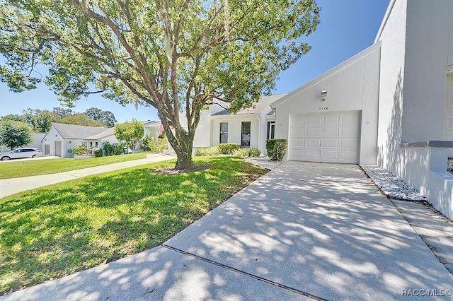 view of front of home with a garage and a front lawn