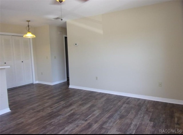 915 SE Mayo Dr, Crystal River, FL 34429 - empty room with ceiling fan, dark wood-style floors, and baseboards