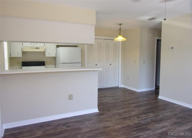 915 SE Mayo Dr, Crystal River, FL 34429 - kitchen with freestanding refrigerator, under cabinet range hood, range, light countertops, and dark wood-type flooring