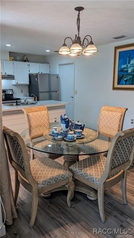 dining space featuring a chandelier and hardwood / wood-style flooring