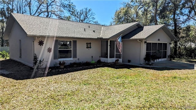 ranch-style home with a front lawn