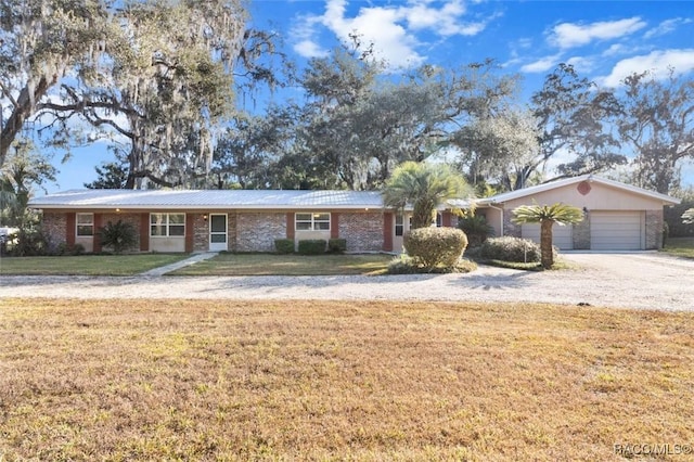 ranch-style home with a front yard and a garage