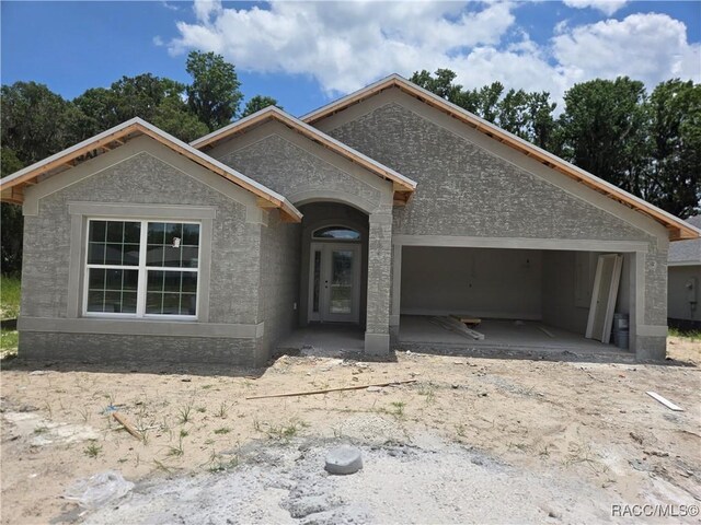 956 Ibis Cir, Inverness, FL 34453 - view of front of home featuring an attached garage and stucco siding
