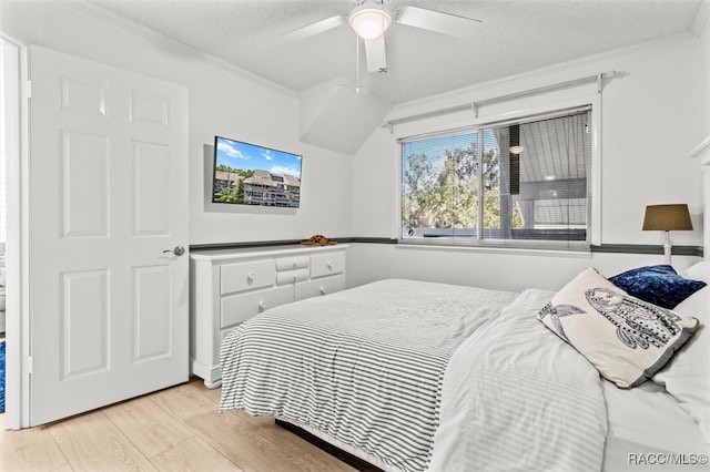 bedroom with a textured ceiling, light hardwood / wood-style flooring, ceiling fan, and crown molding