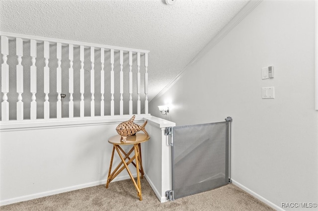 stairs with carpet flooring, crown molding, and a textured ceiling