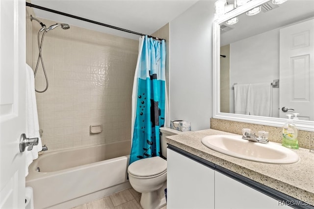 full bathroom with vanity, shower / tub combo, and toilet