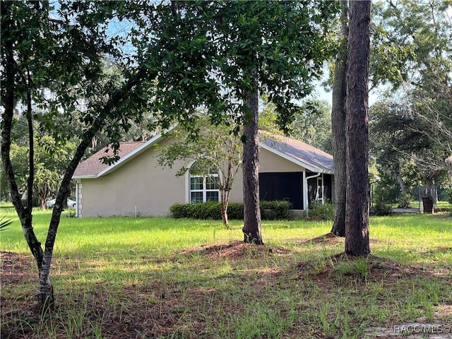2788 W Elm Blossom St, Beverly Hills, FL 34465 - view of side of property with stucco siding and a yard