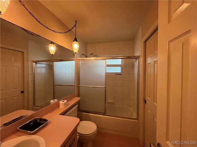 full bathroom with toilet, bath / shower combo with glass door, tile patterned floors, and vanity