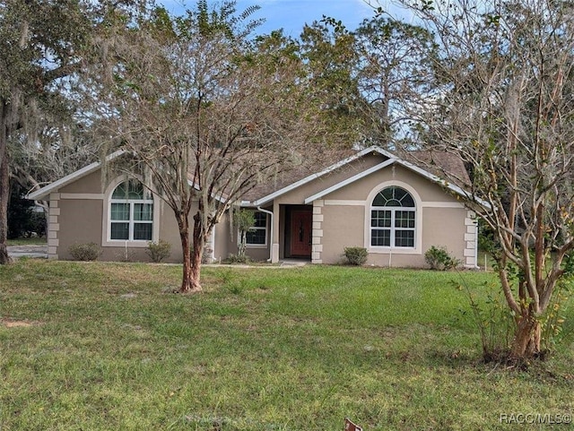 ranch-style home with a front lawn