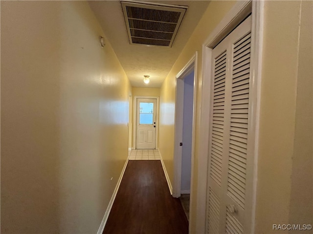 hallway with hardwood / wood-style floors