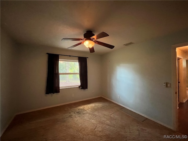 spare room featuring carpet floors and ceiling fan