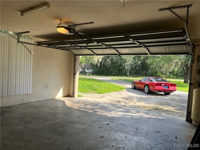 garage featuring ceiling fan and a garage door opener