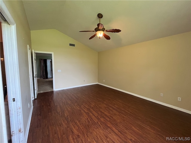 empty room with dark wood-type flooring, lofted ceiling, and ceiling fan