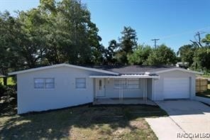 ranch-style house with a garage and a front lawn